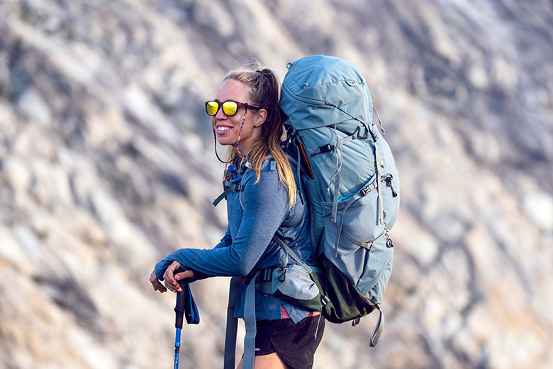 Smiling wearing Deuter Aircontact Core women's backpacking backpack